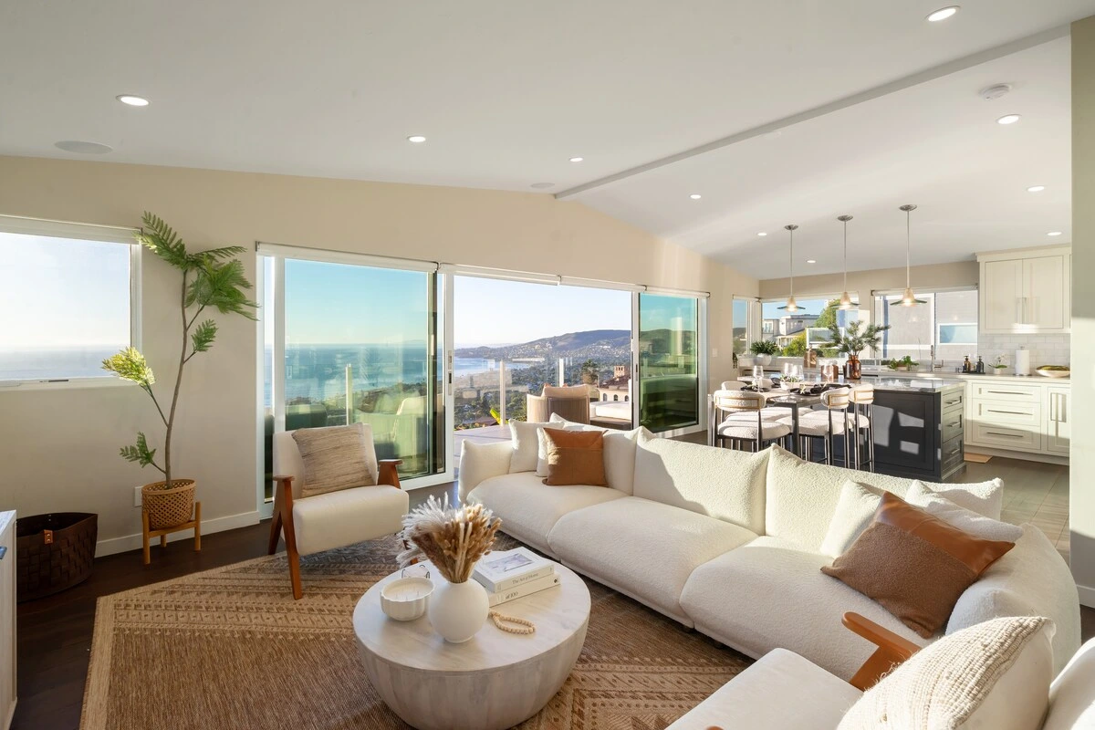 Laguna Beach living room with cream seating and panoramic coastal views