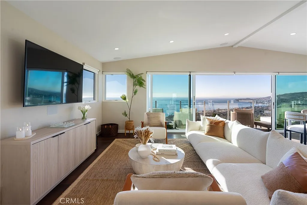 After: Laguna Beach living room with cream seating, natural textures and a round stone table