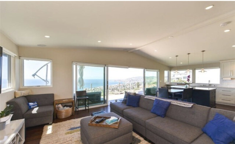 Before: Laguna Beach living room with gray seating and blue cushions
